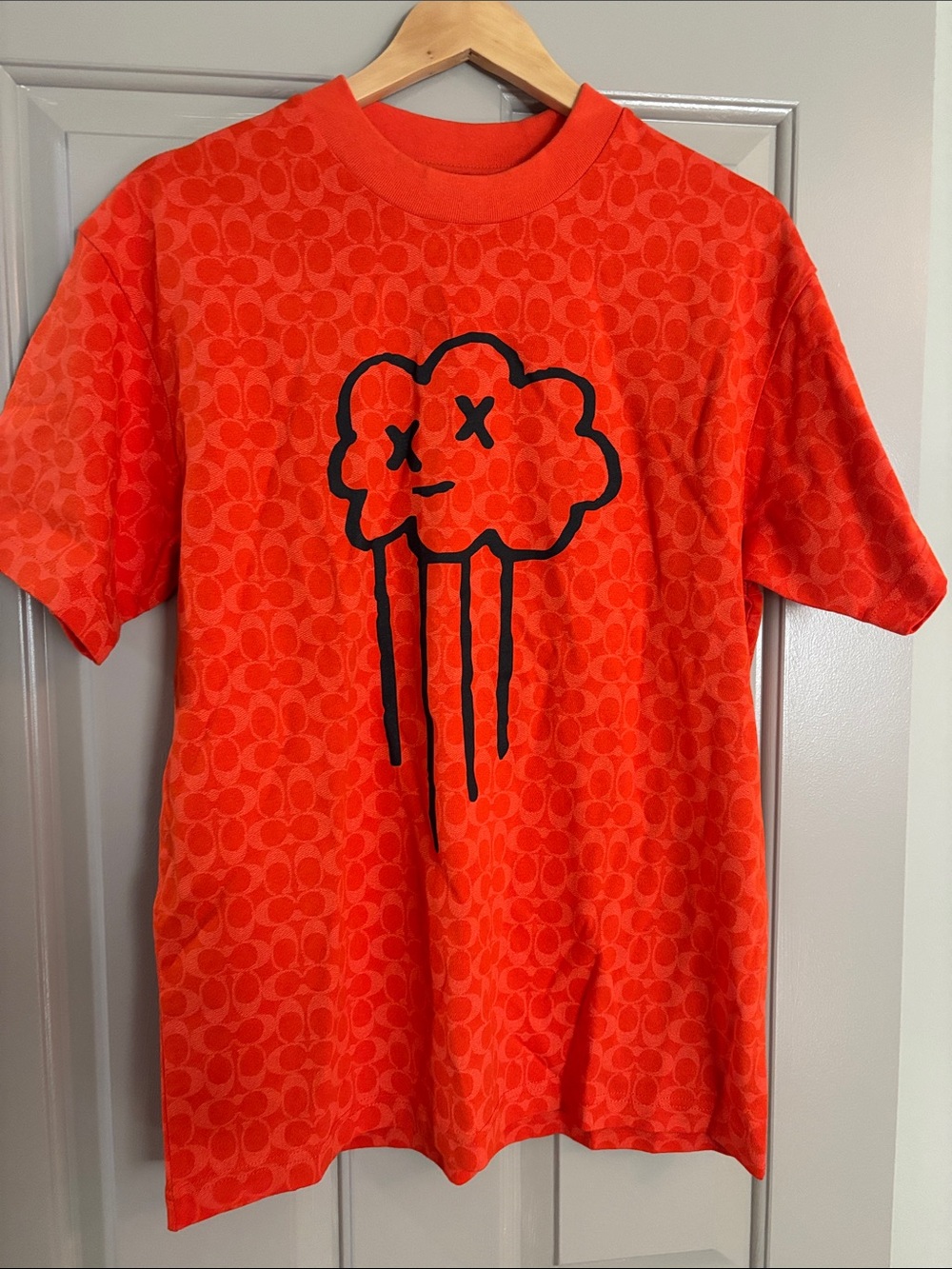 Coach Orange Short-Sleeve Graphic Tee with Black Cloud Motif